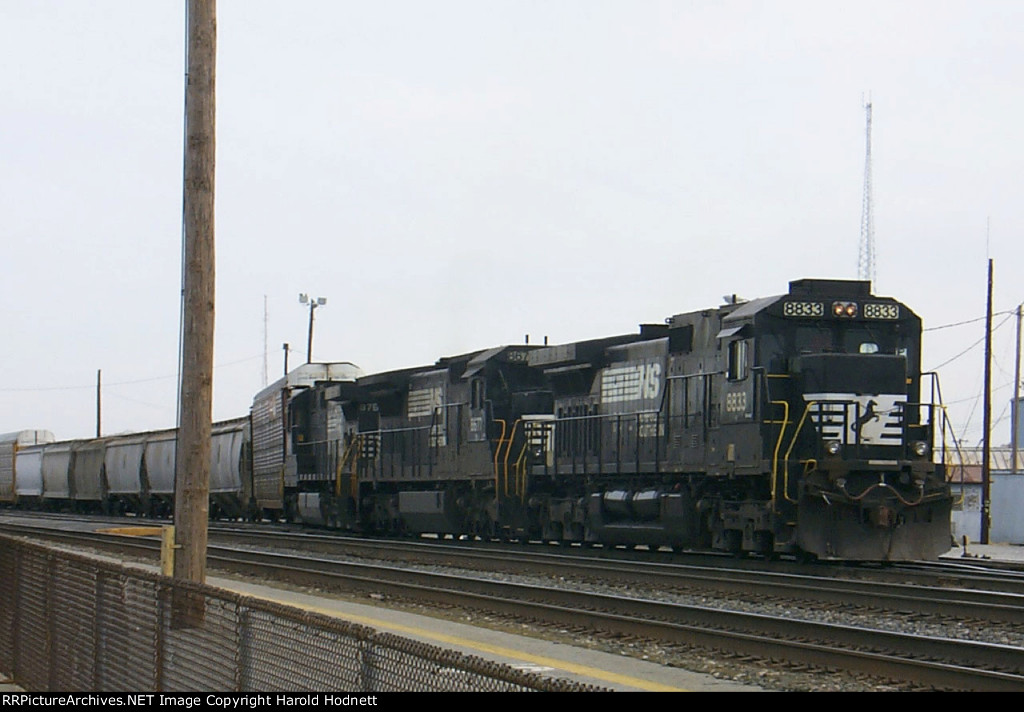 NS 8833 leads a train out of the yard